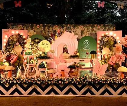 An enchanted garden party that glows with magic. I use string lights, hanging lanterns, and custom fairy and mushroom props to turn a simple lawn into a whimsical forest setting, perfect for an evening celebration.