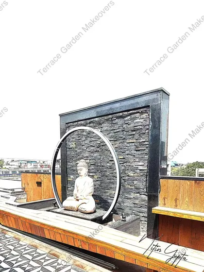 For clients seeking a touch of tranquility, we design and install custom water features. This piece combines a stacked slate waterfall with a meditative Buddha statue, creating a true zen garden experience on a modern terrace.