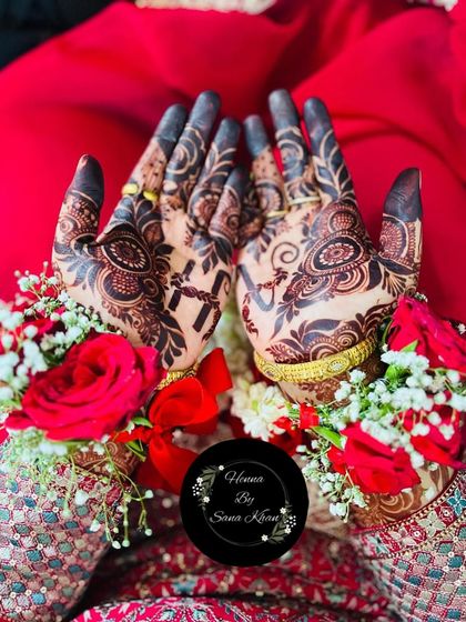 A beautiful, dark stain on a design featuring a Christian cross, perfectly accessorized with floral hand jewelry for a wedding day.