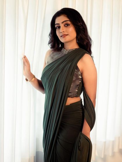 Another look at the elegant dark green drape saree. This rental piece is perfect for those who want a sophisticated and modern ethnic look for a formal event.