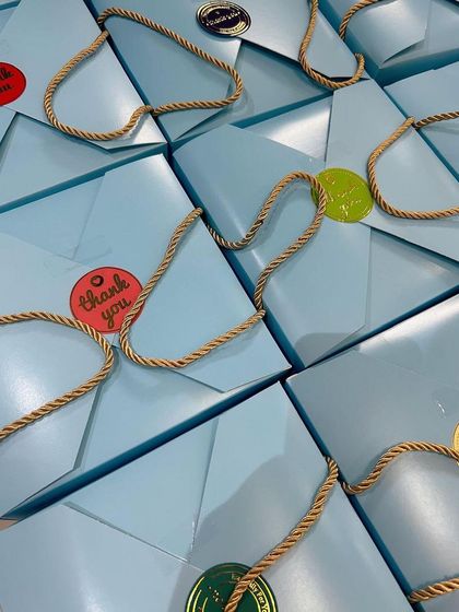 Another shot of the light blue return gift bags, sealed with 'Thank You' stickers. It's a simple and sweet way to thank your guests.