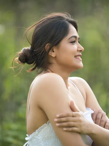 A profile shot capturing a moment of quiet happiness. The soft focus on the background keeps the attention on the model's serene expression.