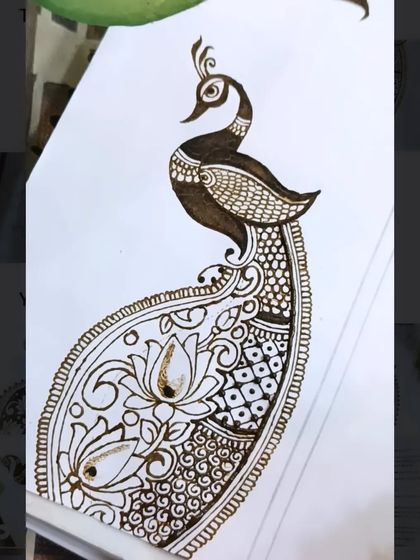 Another angle of the peacock design in progress, showing how the different filler patterns are added to the tail.
