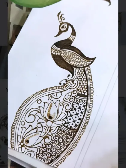 The peacock design is now being filled with intricate details like checks and dots, which adds texture and richness to the overall pattern.