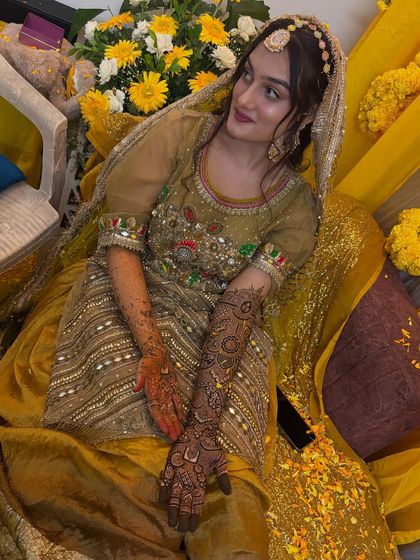 A beautiful portrait of the bride at her mehendi ceremony. The henna on her hands and arms adds so much richness to her look.