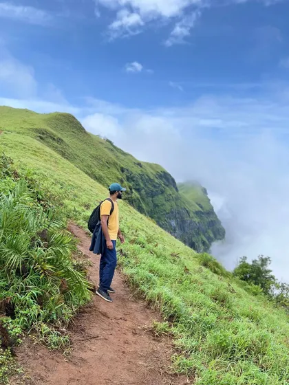 A trekker enjoying a solitary moment with a stunning view on the Bandaje trail.