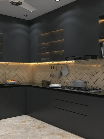 A full view of the moody black kitchen concept. The layout is a practical L-shape, with a herringbone backsplash adding texture and visual interest.
