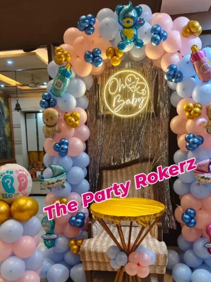 The "Oh Baby" baby shower setup with a cake table placed in front of the balloon arch, ready for the celebration.