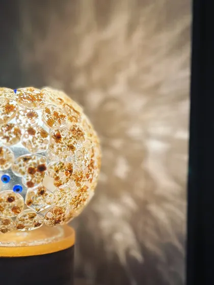 The shadow play from the globe lamp is just as beautiful as the lamp itself. It casts a floral pattern on the wall.