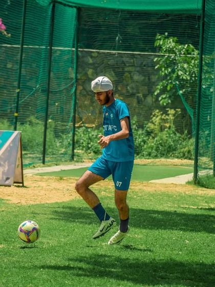 A player practices his juggling skills, keeping the ball airborne with precision.