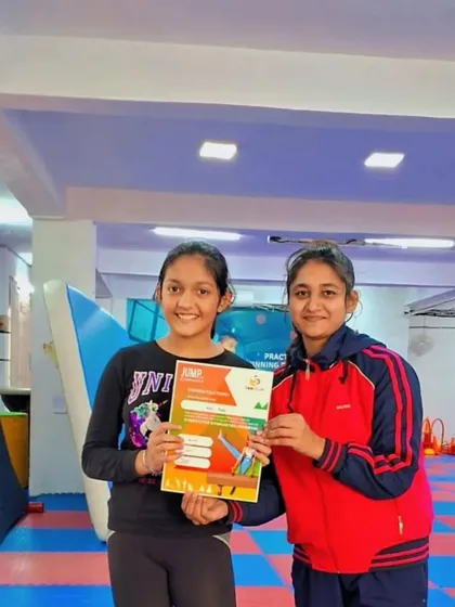 Two students celebrate their achievement together with their coach.