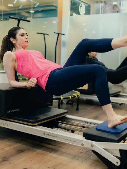 This reverse tabletop position on the reformer box challenges the entire posterior chain, including the glutes, hamstrings, and back, while also engaging the core for stability.