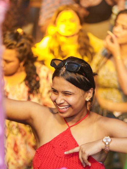 A happy face in the crowd, winking at the camera.