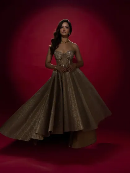 For actress Shanvi Srivastava, I designed this shimmering gold evening gown. The structured corset bodice and flowing, high-low skirt create a dramatic and glamorous silhouette, ideal for red carpet events or a high-fashion engagement party.