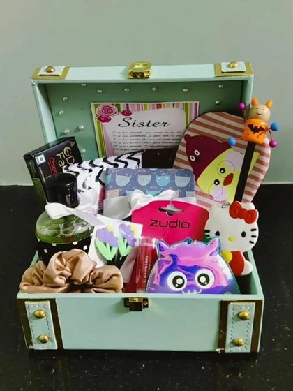 A pastel green trunk filled with goodies for a sister. Each hamper is curated with a unique mix of items to suit her personality.