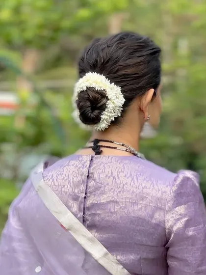 A neat and elegant bun with a simple jasmine gajra. This is a perfect look for a traditional ceremony or family function.