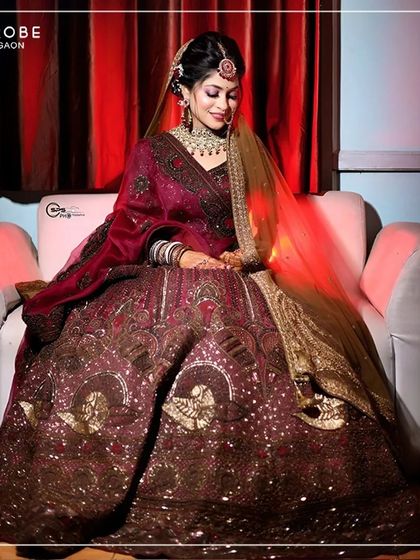 A moment of quiet elegance. This bride looks absolutely regal in a deep maroon velvet lehenga, perfect for a grand evening wedding ceremony.