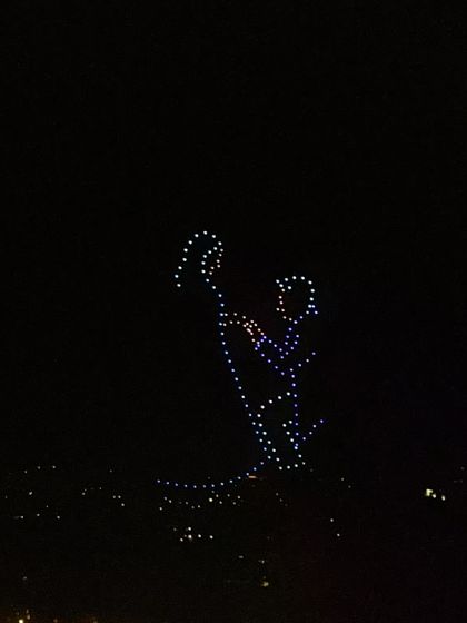 A drone formation depicts a groom proposing to his bride. This timeless, romantic image is one of the many ways we can immortalize your holy union in the sky.