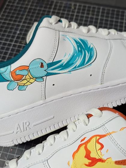 A close-up of the Squirtle side of this "Pokeforce 1" custom. The water splash artfully becomes the Nike swoosh, a creative twist on a classic design.