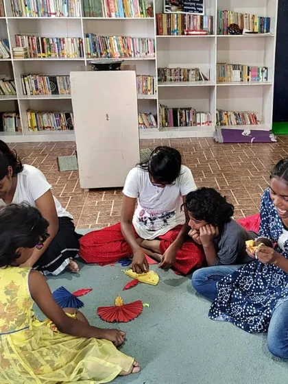 A group of girls sit on the floor, laughing and chatting as they work on their Diwali crafts. These sessions are a wonderful opportunity for social interaction and bonding.
