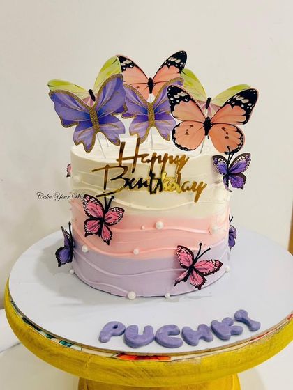 Fluttering into sweetness. This dreamy ombre butterfly cake in shades of purple and pink is perfect for a whimsical celebration.
