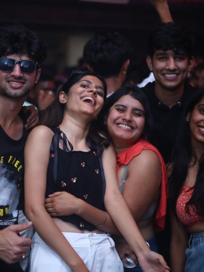 A group of friends laughing and enjoying the night at Flo.