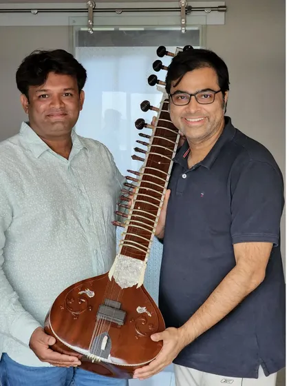 Delivering a custom-made sitar to a happy client. The best part of my job is seeing the joy on a musician's face when they hold their new instrument.
