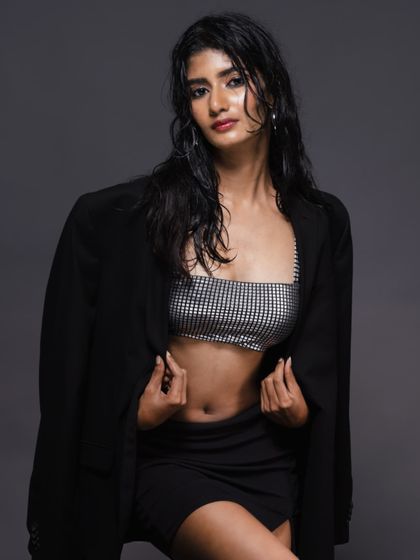 A direct-to-camera shot from the "wet look" series, with a confident and engaging expression.