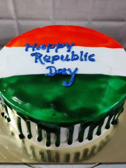 A Republic Day drip cake with a glossy glaze in saffron, white, and green.