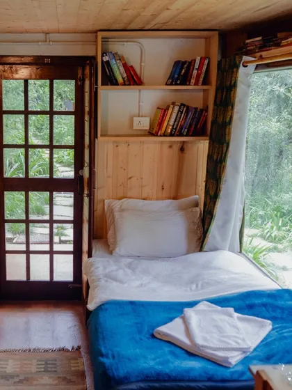 A look inside one of our cozy single rooms. Complete with a comfortable bed, a writing desk, and a bookshelf, it's your personal space to create and reflect.