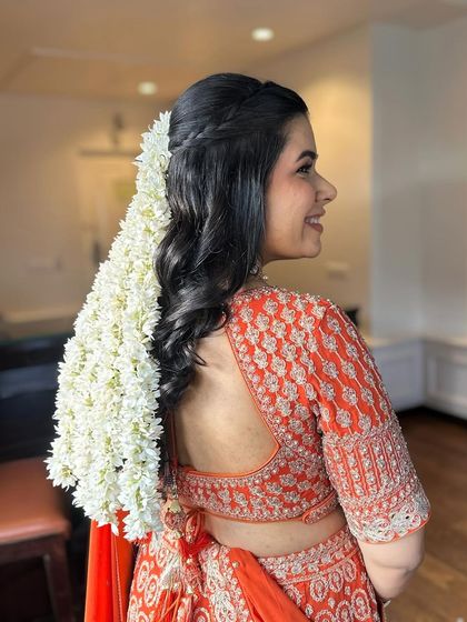 Another angle of Juhi's gentle baby shower look, showing the beautiful hairstyle adorned with fresh mogra that complements the soft makeup.