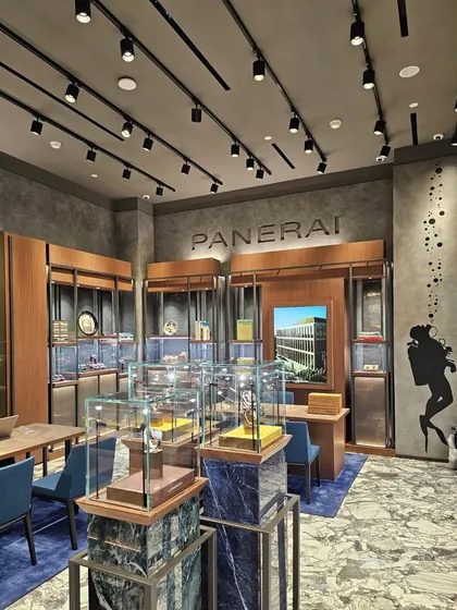 Every detail in the Panerai store is meticulously executed to embody the brand's adventurous spirit. A subtle diver's silhouette graphic on the wall and displays on blue marble pedestals reinforce the nautical theme, while the layout invites exploration of the watch collections.