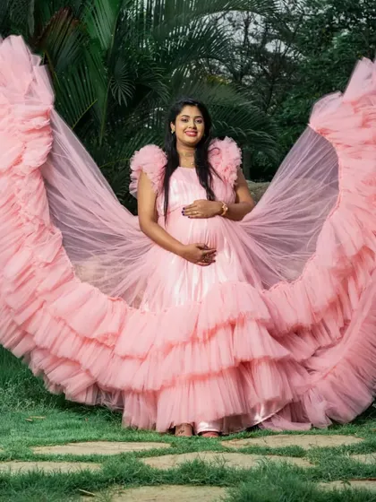 Celebrating motherhood should be glamorous. This dramatic pink ruffled gown is part of my rental collection for maternity photoshoots, designed to make expectant mothers feel beautiful and celebrated.