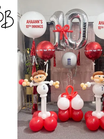 Howzat! A perfect setup for a young cricket fan's 10th innings. This arrangement includes two cricketer sculptures, a personalized "10th Innings" message, and cricket ball details for a sporty celebration.