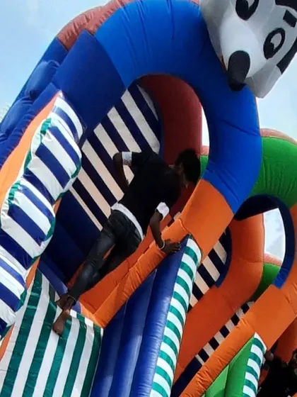 This picture shows the strength and durability of the material I use. You can see a person climbing the structure, which demonstrates that my inflatables are built to withstand active play and are safe for commercial rental use.