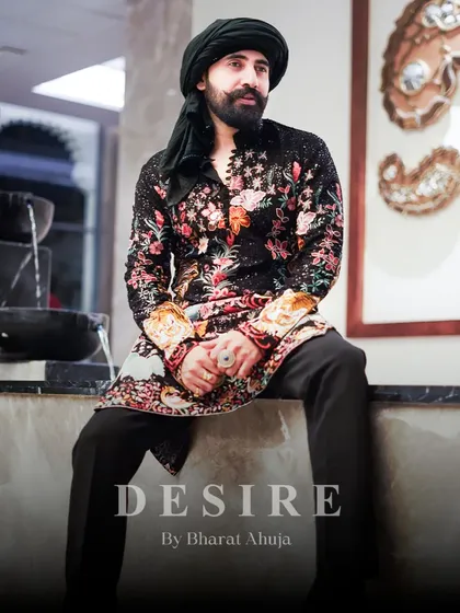 Seated in confidence, wearing a masterpiece. This full-length view shows how my floral and tiger embroidered kurta creates a complete, powerful silhouette. It is designed to make an impact from every angle.