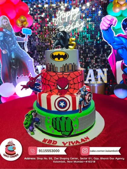 Your party theme can extend to the cake as well. As part of my combo deal with Cake Corner, we created this four-tier superhero cake to match the party's Marvel and DC theme. The background shows the matching shimmery backdrop and balloon colors.