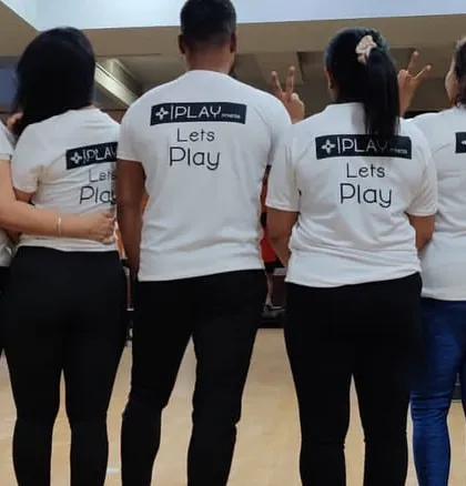 Our team shirts say it all: "Lets Play". This photo from behind shows our members united as a team, ready to take on any fitness challenge together.
