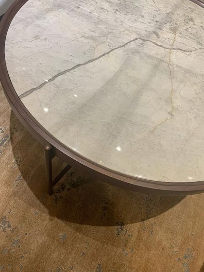 The beautiful natural veining in a marble coffee table, a reminder that nature is the ultimate artist.