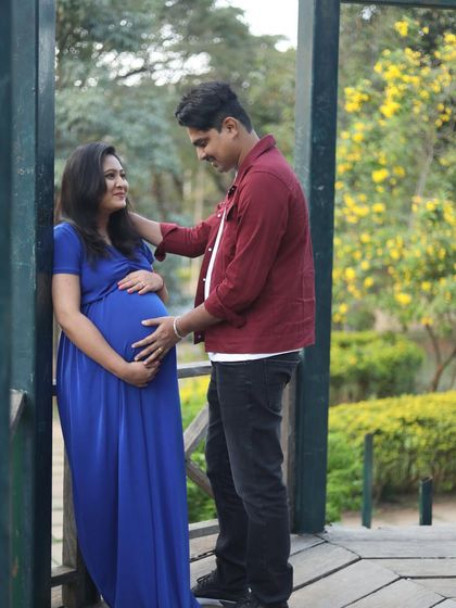 A candid, romantic moment on a bridge. The outdoor setting and her natural makeup create a beautiful, timeless memory.