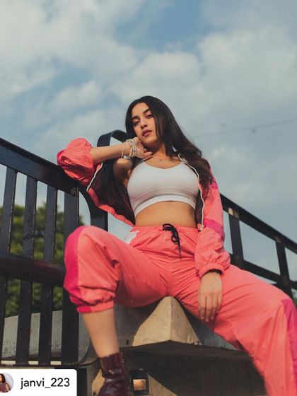 A shot from a photoshoot where I styled a sporty, athleisure look. This pink and white tracksuit paired with a simple white crop top creates a modern, confident, and relaxed vibe.