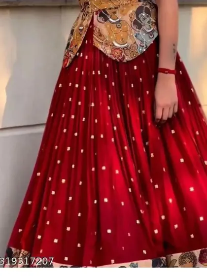 A closer look at the flared red georgette skirt from the Kalamkari print set. You can see the delicate sequin work and the printed border that complements the unique blouse.