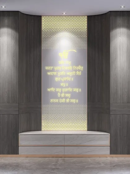 This modern pooja space features a backlit panel with Sikh prayers in Gurmukhi script. The dark wood cabinetry and clean lines create a serene and contemporary spiritual corner.