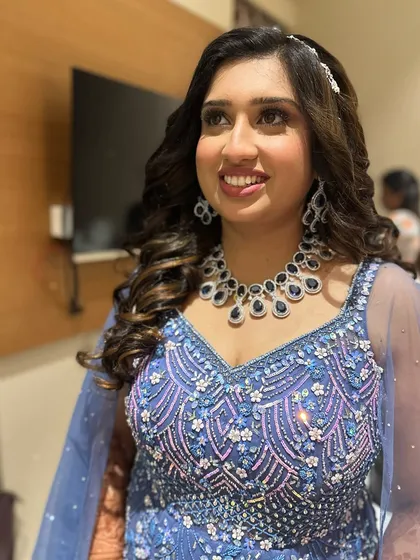 Amazing glam for this reception bride. The purple-toned eyeshadow and diamond jewelry create a stunning, modern look.