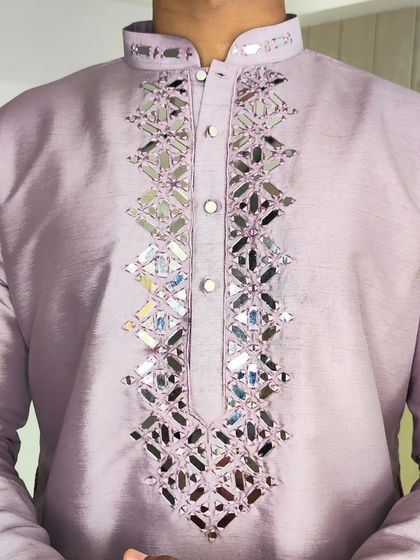 A close-up of the lavender kurta, showing the intricate and sparkling mirror work detail.