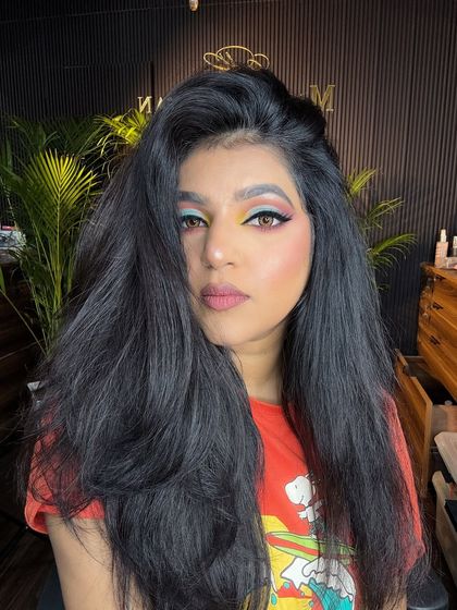 A creative and colorful look with a mix of yellow, pink, and blue eyeshadow. Perfect for someone who loves to experiment with colors.