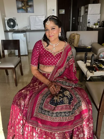 The final look for the bride's sister. The makeup is soft, radiant, and perfectly complements her beautiful lehenga.