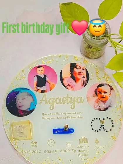 This beautiful first birthday gift for baby Agustya was ordered by his bua (aunt). I designed this 12-inch round frame with a light, pearly background and gold leaf details. It preserves his umbilical cord, first bracelets, photos, and a heartfelt message from his aunt.