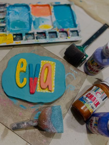 This personalized clay nameplate was created for Eva's birthday party. It's a wonderful example of how we can customize activities to make the birthday star feel extra special.