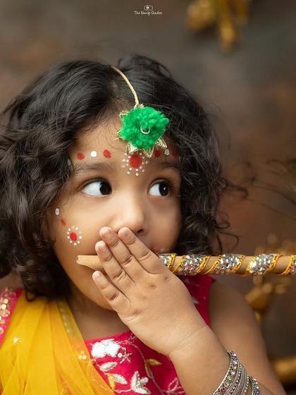 A playful moment as the little girl holds a flute to her mouth.